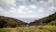 This picture shows the Atlantic Ocean and farms seen from the Plantation House, the United Kingdom Governor official residence on October 20, 2017 in Saint Helena, a British Overseas Territory in the South Atlantic Ocean. / AFP / GIANLUIGI GUERCIA