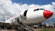 In this photograph taken on July 18, 2017 Nepali pilot Bed Upreti walks from an airplane that has been converted into an aviation museum in Kathmandu./ AFP / PRAKASH MATHEMA