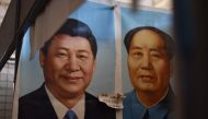 This file picture taken on September 19, 2017 shows painted portraits of Chinese President Xi Jinping (L) and late communist leader Mao Zedong at a market in Beijing. AFP / Greg Baker