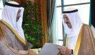 A handout photo provided by the Kuwaiti news agency KUNA shows Kuwaiti Prime Minister Sheikh Jaber al-Mubarak al-Sabah (L) handing over the government's resignation letter to the Emir of Kuwait Sheikh Sabah al-Ahmad al-Sabah on October 30, 2017, in Kuwait