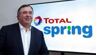 Total Chief Executive Officer Patrick Pouyanne poses next to the logo of Total Spring during a news conference in Paris, France, October 5, 2017. Reuters/Charles Platiau