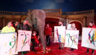 Sandra, a 42-year-old elephant, poses for a photo with Hungarian circus fans who bought her painting in the Florian Richter Circus in Budapest, Hungary November 4, 2017. REUTERS/Laszlo Balogh