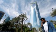 A man speaks on the phone as he walks past the Kingdom Centre Tower in Riyadh, Saudi Arabia, November 5, 2017. REUTERS/Faisal Al Nasser
