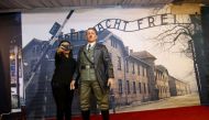 This photograph taken on November 10, 2017 shows an Indonesian woman take a selfie with a life-size wax sculpture of Adolf Hitler at a museum in Yogyakarta. AFP / HENRYANTO