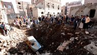 People look at the damage in the aftermath of an air strike in the Yemeni capital of Sanaa on November 11, 2017.  AFP
