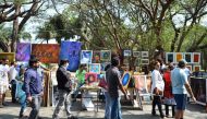 (FILES) This file photo taken on January 15, 2017 shows Indian visitors walking through exhibitions at the annual 'Chitra Santhe' art fair in Bangalore. AFP / MANJUNATH KIRAN 
