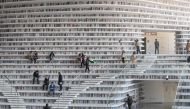 This picture taken on November 14, 2017 shows people visiting the Tianjin Binhai Library. AFP / Fred Dufour 