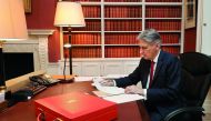 Britain's Chancellor of the Exchequer Philip Hammond poses putting finishing touches to his speech in his office in Downing Street central London on November 21, 2017 on the eve of his 2017 budget announcement. AFP/ Christopher Furlong