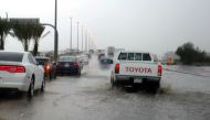 Saudi drivers take a flooded street in Jeddah on November 21, 2017. / AFP / Amer HILABI