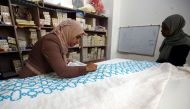 A Palestinian woman embroiders at a workshop in Jordan's Jerash Palestinian refugee camp. AFP / KHALIL MAZRAAWI
