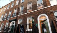 (FILES) This file photo taken on February 06, 2012 shows a general view shows a man exiting the Charles Dickens Museum based in a house where the British novelist lived in central London on February 6, 2012. AFP / Carl COURT
