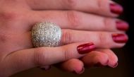 A model shows a solid gold 18K white dome ring, originally a gift from Richard Burton to Elizabeth Taylor, November 29, 2017 at a media preview for the world's first live streaming runway auction of a $25 million collection of rare Chanel fashion as well 