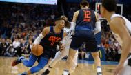  San Antonio Spurs guard Brandon Paul (3) pursues Oklahoma City Thunder guard Russell Westbrook (0) around a screen set by Oklahoma City Thunder center Steven Adams (12) during the second quarter at Chesapeake Energy Arena.  Mark D. Smith 
