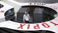 Tokyo Stock Exchange staff members work at the bourse at TSE in Tokyo. Photo: Reuters.