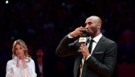 LOS ANGELES, CA - DECEMBER 18: Kobe Bryant addresses the crowd at halftime as both his #8 and #24 Los Angeles Lakers jerseys are retired at Staples Center on December 18, 2017 in Los Angeles, California. Harry How/AFP