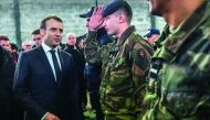 French President Emmanuel Macron (L) speaks to soldiers as he meets security forces during his visit in the French northern city of Calais on January 16, 2018. French President Emmanuel Macron travelled to the northern French port of Calais ahead of a sum