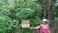 A farmer displays a beehive that is part of an elephant control beehive fence in Mayilattumpara village in India's Kerala state, October 2017. Thomson Reuters Foundation/K. Rajendran