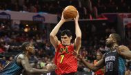 Ersan Ilyasova #7 of the Atlanta Hawks drives to the basket against teammates Marvin Williams #2 and Michael Kidd-Gilchrist #14 of the Charlotte Hornets during their game at Spectrum Center on January 26, 2018 in Charlotte, North Carolina. Streeter Lecka/