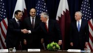 U.S. Defense Secretary Jim Mattis (R) looks on as Secretary of State Rex Tillerson shakes hands with Qatari Foreign Minister Sheikh Mohammed bin Abdulrahman Al Thani (L) and Defense Minister Khalid bin Muhammad al-Attiyah at the opening session of the ina