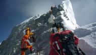 (FILES) In this file photograph taken on May 19, 2009, mountaineers walk past the Hillary Step while pushing for the summit of Mount everest as they climb the south face of the mountain from Nepal. AFP / STR 