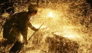 In this file photo taken on April 12, 2006 an iron and steel worker makes a test on a casting at Ascometal factory in Fos-sur-Mer, south-eastern France. AFP / Boris Horvat