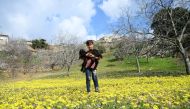 A 9-year-old kid Meryem Bakir poses for a photo with her goat as she walks around freely after returning to her house with her family members in Omer Ushagi village, located west of Afrin on February 25, 2018. Soner K?l?nç - Anadolu