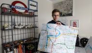 Matej Hosek, a Czech schoolboy with Asperger syndrom, shows a map that he designed, on January 29, 2018, in his bedroom in the village of Cernosice, Czech Republic. AFP / Michal Cizek 