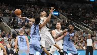 San Antonio Spurs point guard Tony Parker (9) is fouled while shooting by Memphis Grizzlies point guard Kobi Simmons (2) during the first half at AT&T Center.  Soobum Im