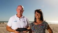 This undated photo received courtesy from Kym Illman on March 7, 2018 shows Kym Illman (L) and his wife Tonya posing with a bottle which contained an almost 132-year-old message that was found near Wedge Island, some 160 kilometres (99 miles) north of Per