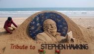 Sand artist Sudarsan Patnaik gives final touches to a sculpture in honour of British physicist and award-winning author Stephen Hawking at Puri beach, some 65 kms. from Bhubaneswar on March 14, 2018.  AFP / Asit Kumar