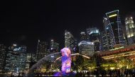 Merlion statue lit up in front of the city skyline in Singapore. The eye-watering cost of owning a car in space-starved Singapore means the city state is the world's most expensive place to live for the fifth year in a row, a survey said on March 15. (AFP