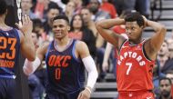 Toronto, Ontario, CAN; Oklahoma City Thunder guard Russell Westbrook (0) and Toronto Raptors guard Kyle Lowry (7) react after a play at the Air Canada Centre. Oklahoma City defeated Toronto. John E. Sokolowski
