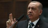 Turkish President and leader of the Justice and Development Party (AK Party) Recep Tayyip Erdogan gestures as he delivers a speech during the AK Party's parliamentary group meeting at the Grand National Assembly of Turkey (TBMM) in Ankara on March 20, 201