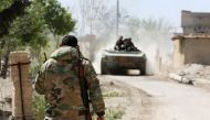 Syrian pro-regime forces advance on the outskirts of Ain Tarma in Eastern Ghouta as they continue to press their offensive to capture the rebel-held enclave on the doorstep of Damascus on March 21, 2018. / AFP / STRINGER