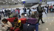 A Brazilian soldier patrols past travelers in the Galeao international airport in Rio de Janeiro, July 24, 2016. Reuters / Ricardo Moraes