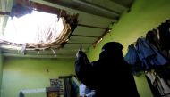 A woman uses her mobile phone to take picture of the damage created by debris, after ballistic missiles fired by Yemen's Houthi militia, fell at a house in Riyadh, Saudi Arabia March 26, 2018. REUTERS/Faisal Al Nasser