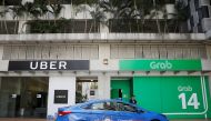 A ComfortDelgro taxi passes Uber and Grab offices in Singapore March 26, 2018. Reuters/Edgar Su