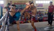 In this photograph taken on March 27, 2018, fighters Thway Thit Win Hlaing (L) and Saw Ba Oo (R), representing Myanmar's Karen state, battle during a ground-breaking Lethwei competition in the Maungdaw district of violence-rocked Rakhine state, close to t