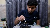 Radwan Nasser Abdel Amir, a former Iraqi soldier, 28, creates a mini-diorama to preserve war scenes in Mosul, in Kerbala, Iraq, April 1, 2018. Reuters/Abdullah Dhiaa Al-deen