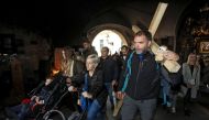 Sasa Pavlic walked 200 kilometres carrying a heavy wooden cross on his back to protest Croatia's purchase of military jets (AFP Photo/STR)