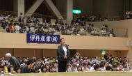 Tomoko Nakagawa (C), the mayor of the western Japanese city of Takarazuka, delivering a speech outside the sumo ring (R) during a local exhibition in Takarazuka, Hyogo prefecture on April 6, 2018. AFP Photo / Takarazuka City