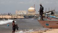 A fisherman stands on his boat on a beach near Kudankulam nuclear power project in Tamil Nadu, India, September 13, 2012. (Reuters / Adnan Abidi) 