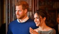 Britain's Prince Harry and his fiancee Meghan Markle watch a performance by a Welsh choir in the banqueting hall during a visit to Cardiff Castle in Cardiff, Britain, January 18, 2018. Reuters/Ben Birchall