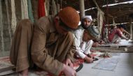 Afghan refugees weave carpet at a Karachi refugee camp February 12, 2009 Reuters/Athar Hussain