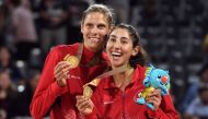 Canada's Sarah Pavan (L) and Melissa Humana-Paredes (R) kiss their gold medals after winning the women's beach volleyball final against Australia at the 2018 Gold Coast Commonwealth Games in Gold Coast on April 12, 2018. AFP / William West