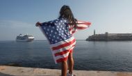 A woman with a US flags looks at the arrival of US Carnival cruise ship Adonia at the Havana bay,  May 2, 2016. Reuters