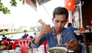 Vietnamese deportee and Amerasian Pham Chi Cuong, 47, who was deported from U.S., eats along a street in central Ho Chi Minh City, Vietnam April 20, 2018, Reuters/Kham