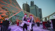 Mime actors holding another outside the AMC cinema in the capital Riyadh ahead of the first test film screening in over three decades.  AFP photo / Saudi Royal Palace / Bandar Al-Jaloud
