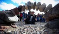 Overall winner, Pedro Duran from Spain, competes in the European Stone Stacking Championships 2018 in Dunbar, Scotland, on April 22, 2018.  AFP / Andy Buchanan