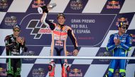 First placed Repsol Honda Team's Spanish rider Marc Marquez (C), second placed Monster Yamaha Tech 3's French rider Johann Zarco (L) and third placed Team SUZUKI ECSTAR's Italian rider Andrea Iannone celebrate on the podium after the MotoGP race of the Sp